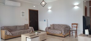 Panoramic Cottage, 3 Bedrooms, Sea View | Living area | 50-inch Smart TV with cable channels, TV