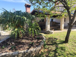 Surrounded by lush greenery and vibrant flowers, this serene garden offers a peaceful retreat.