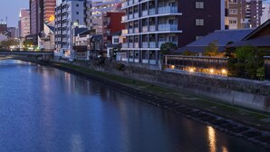 A modern hotel with multiple floors, balconies, and a prominent sign. - ALFACIO RIVERSIDE STAY HAKATA (Fukuoka)