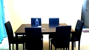 A conference room with a rectangular table, four chairs, and two laptops. - OYO HOME 90768 Flo Inn Motel (Tawau)