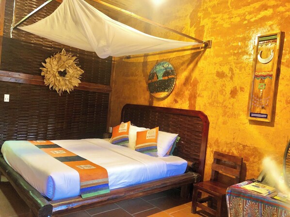 A bed with a canopy, a wooden headboard, and a wall-mounted decorative item.