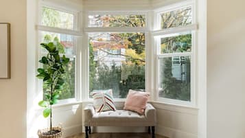 A bay window with a cushioned bench and a potted plant.