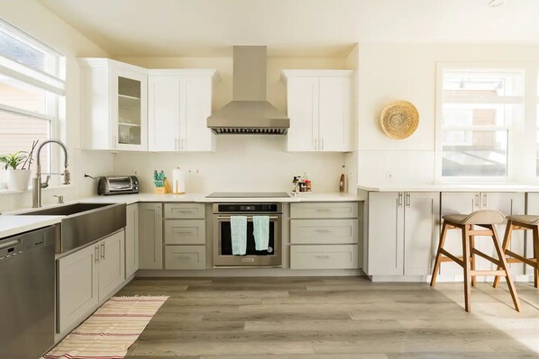 Enjoy cooking in this kitchen with a central island, oven, and stainless steel appliances.