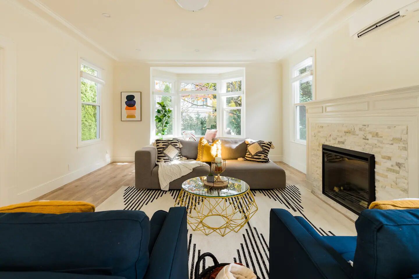 A living room with a sofa, a coffee table, and a fireplace.