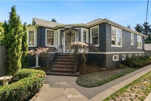 Stunning two-story home with a covered porch and beautifully manicured grounds.
