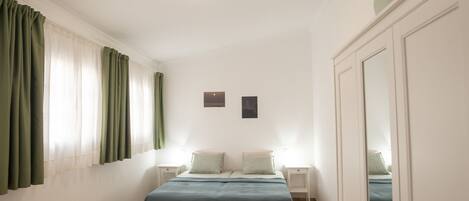 1 bedroom, desk, iron/ironing board, travel crib