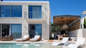 A modern two-story house with a swimming pool, outdoor seating, and a covered patio area. - BRAND NEW Lux Villa*Private Heated SaltyPool*BBQ*SeaView (Daratsos)