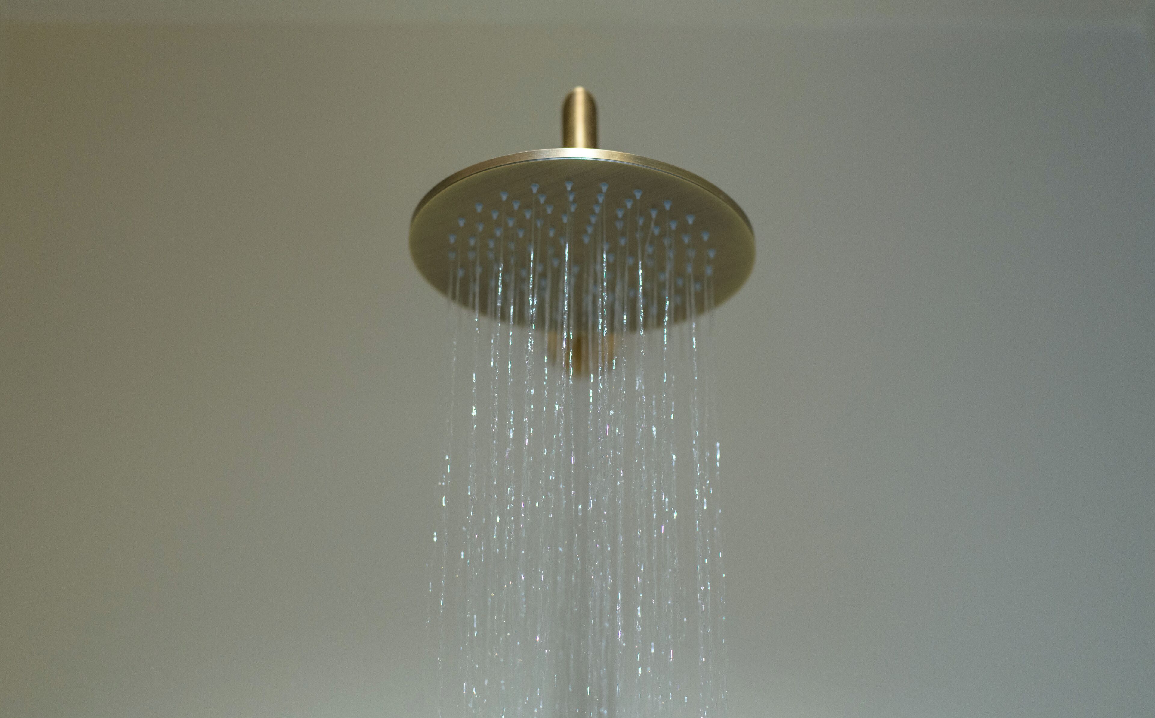 A showerhead with water flowing down.