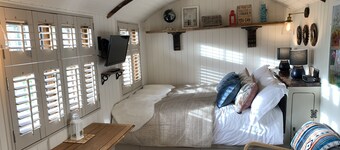 Luxury heated shepherd's hut in field location.