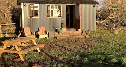 Luxury heated shepherd's hut in field location.
