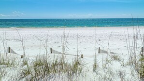 A beach with white sand and clear blue water. - Heated Pool • Sauna • Hot Tub • Game Room • Beach • Golf Cart • Sleeps 15 (Port St. Joe)