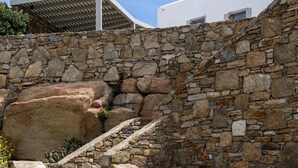 A stone staircase leading up to a white building with a covered area. - VILLA FAROS NEAR PORT, MYKONOS BY MYKONOS AGENDA (Mykonos)