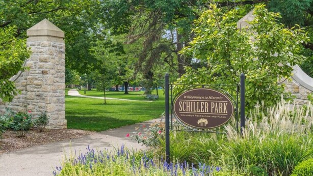 A stone entrance gate with a sign welcoming visitors to Schiller Park, part of Columbus Recreation and Parks. - Stately Executive Home with Modern Amenities (Columbus)