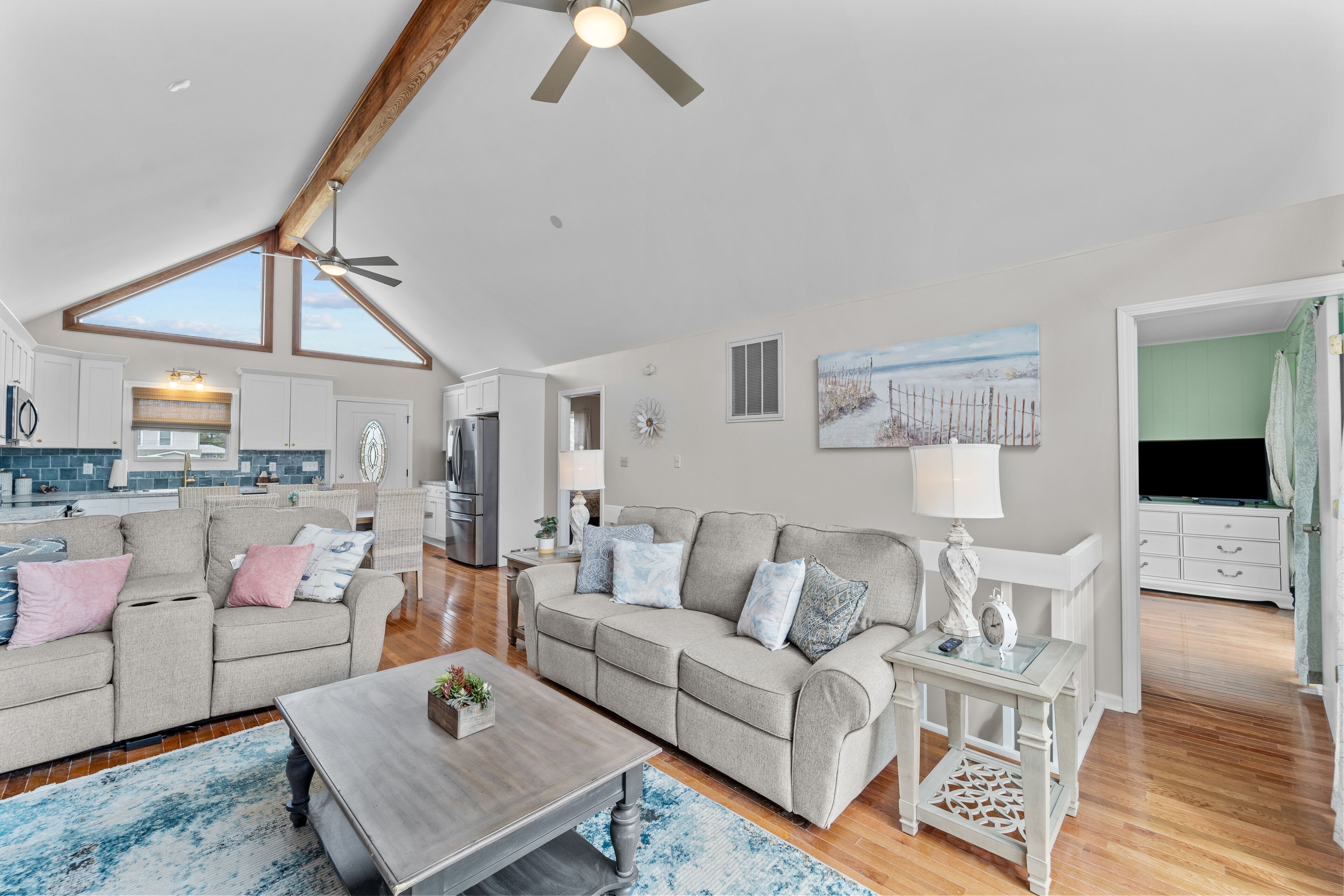 Waterfront home with canal views, dock, kayaks, sunroom, deck, & firepit