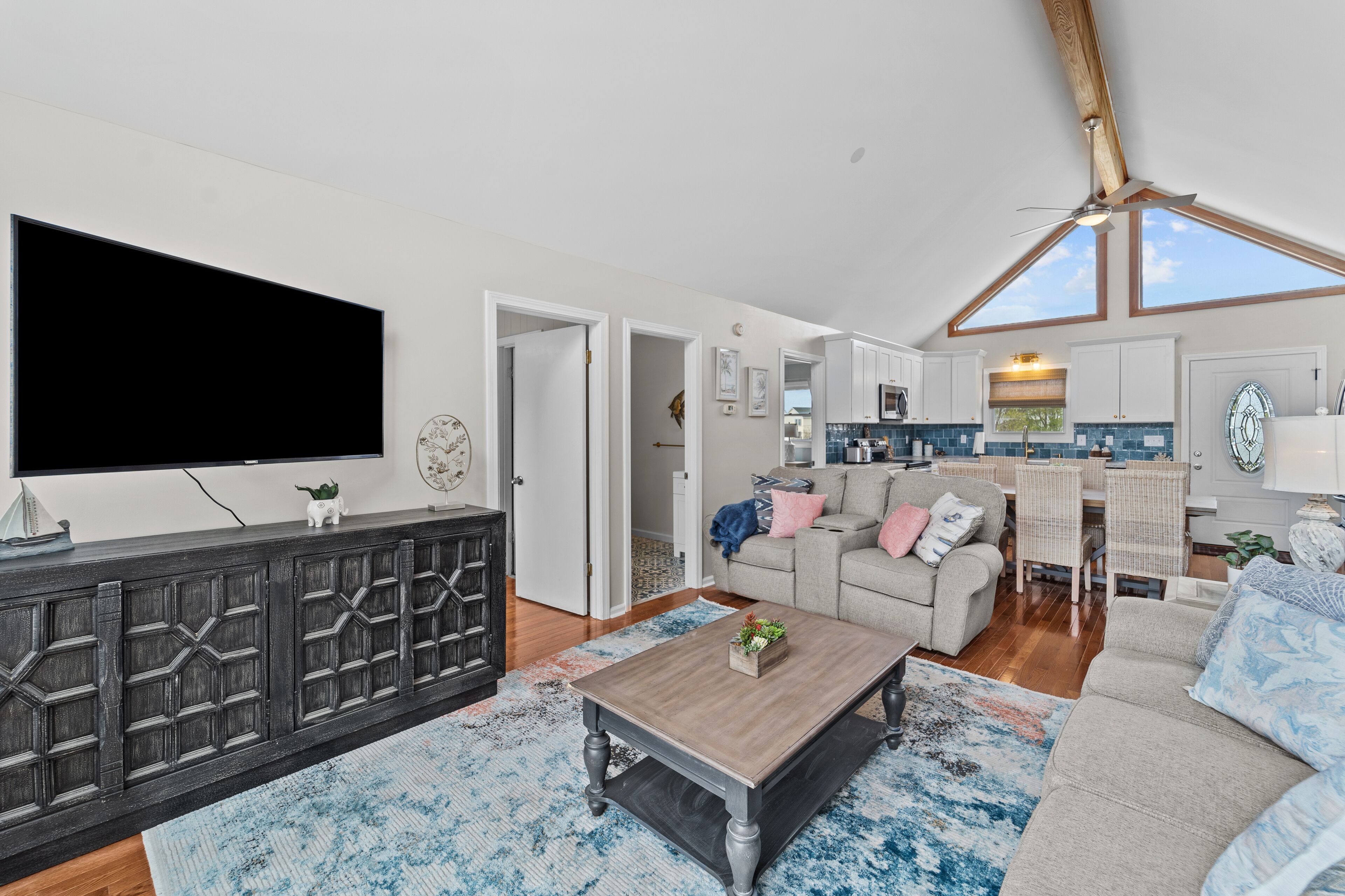 Waterfront home with canal views, dock, kayaks, sunroom, deck, & firepit