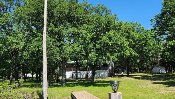 Property grounds - The home is lakefront, perfect! From the roadside, it's nearly impossible to see (Bonham)