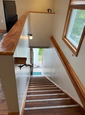 A wooden staircase with a handrail, a light fixture, and a window with a view of greenery outside. - Private, great loc - ideal for long / short stay! (Canton)