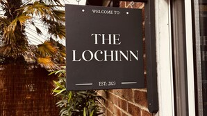 A black sign with white lettering that reads "WELCOME TO THE LOCHINN EST: 2023" mounted on a brick wall. - Margate Beach house (Cliftonville)