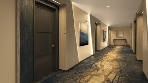 A hallway with a patterned carpet, wooden walls, and a door with a number plate. - 1BD/Atlanta - Downtown w/Rooftop Pool and Pool Bar! (Atlanta)