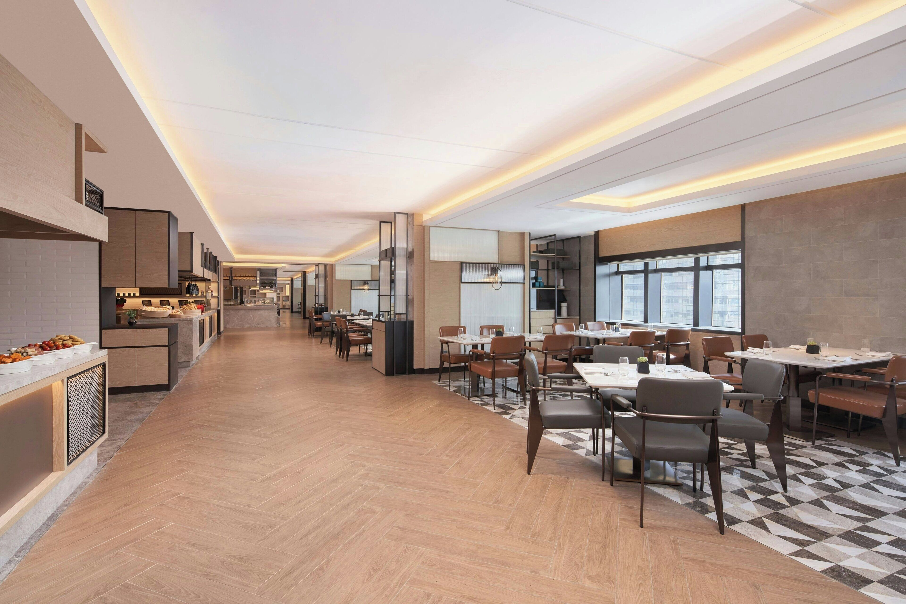 A modern dining area with a long counter, multiple tables, and chairs.