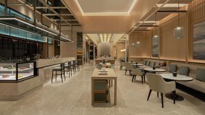 A modern hotel lobby with a bar area, seating arrangements, and a central table. - Courtyard by Marriott Foshan (Foshan)