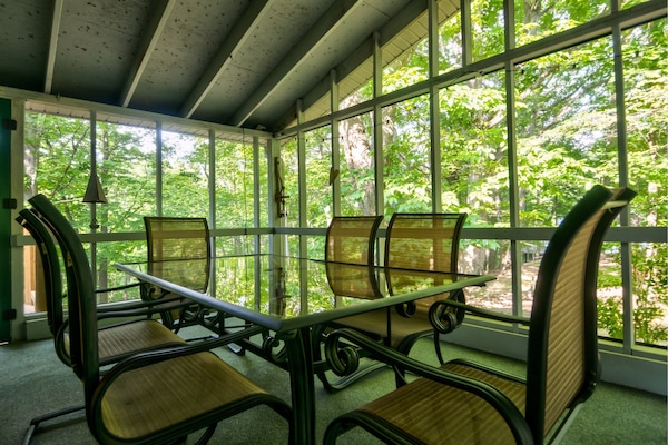 Dine al fresco on the screened in porch.