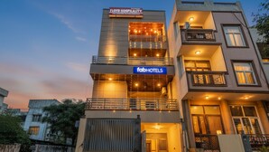 A multi-story hotel with a 'fabHOTELS' sign, a balcony, and a gated entrance. - Fabhotel Floyd (New Delhi)