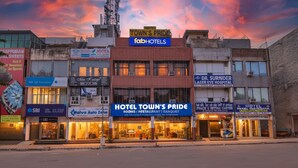 A hotel named "Hotel Town's Pride" with signage for "Fab Hotels" and "Dr. Surnider Laser Eye Hospital" across the street. - Fabhotel Town Pride (Mohali)