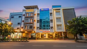 A hotel with multiple buildings, including 'GUD STAY' and 'SURBHI' branded hotels, with a modern architectural design and a clear sky in the background. - Fabhotel Surbhi (Bhopal)