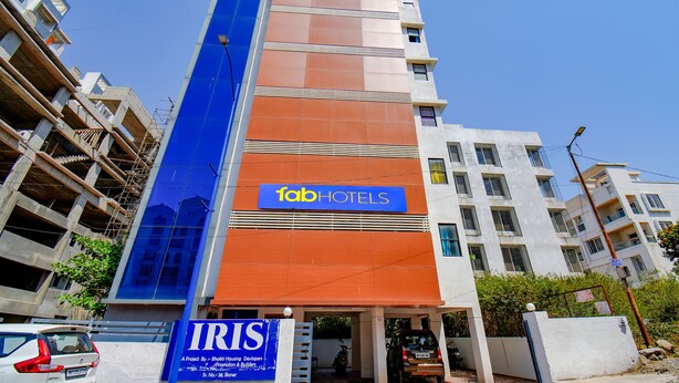 Un immeuble à plusieurs étages, sur lequel on peut voir une enseigne bien visible indiquant « fab hotels », ce qui signifie qu’il s’agit d’un établissement hôtelier.