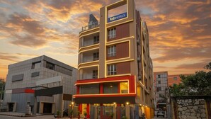 A multi-story building with a modern facade, a prominent 'fabHOTELS' sign, and a gated entrance with potted plants. - FabHotel Lake View Topsia (Kolkata)