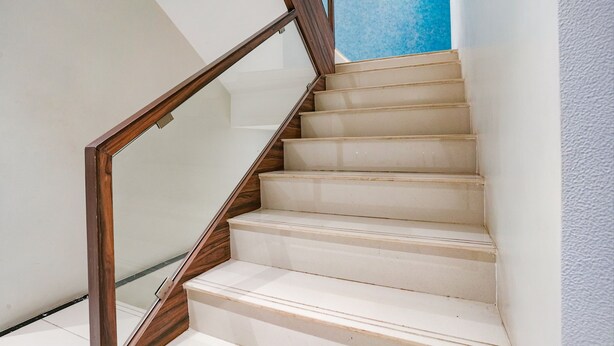 A staircase with wooden handrails and white steps. - Fabexpress The Dream Residency (Mumbai)