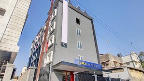 A multi-story building with a 'Fab Hotels' sign, featuring a modern architectural style with a flat roof and a mix of window sizes. - Fabhotel Ashray Residency (Navi Mumbai)