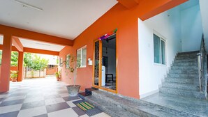 A hotel corridor with a checkered floor, a staircase, and a door leading to a room. - FabHotel Virksham Thrivyn (Coimbatore)