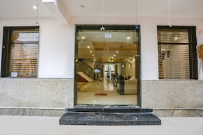 A hotel entrance with a marble floor, a staircase, and a reception desk. - FabHotel Taj Residency (New Delhi)