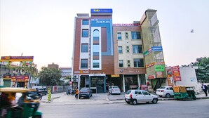 A multi-story building with signs for 'Hotel Palm Plaza' and 'Hotel Galaxy Jewel'. - Fabhotel Palm Plaza (Dera Bassi)