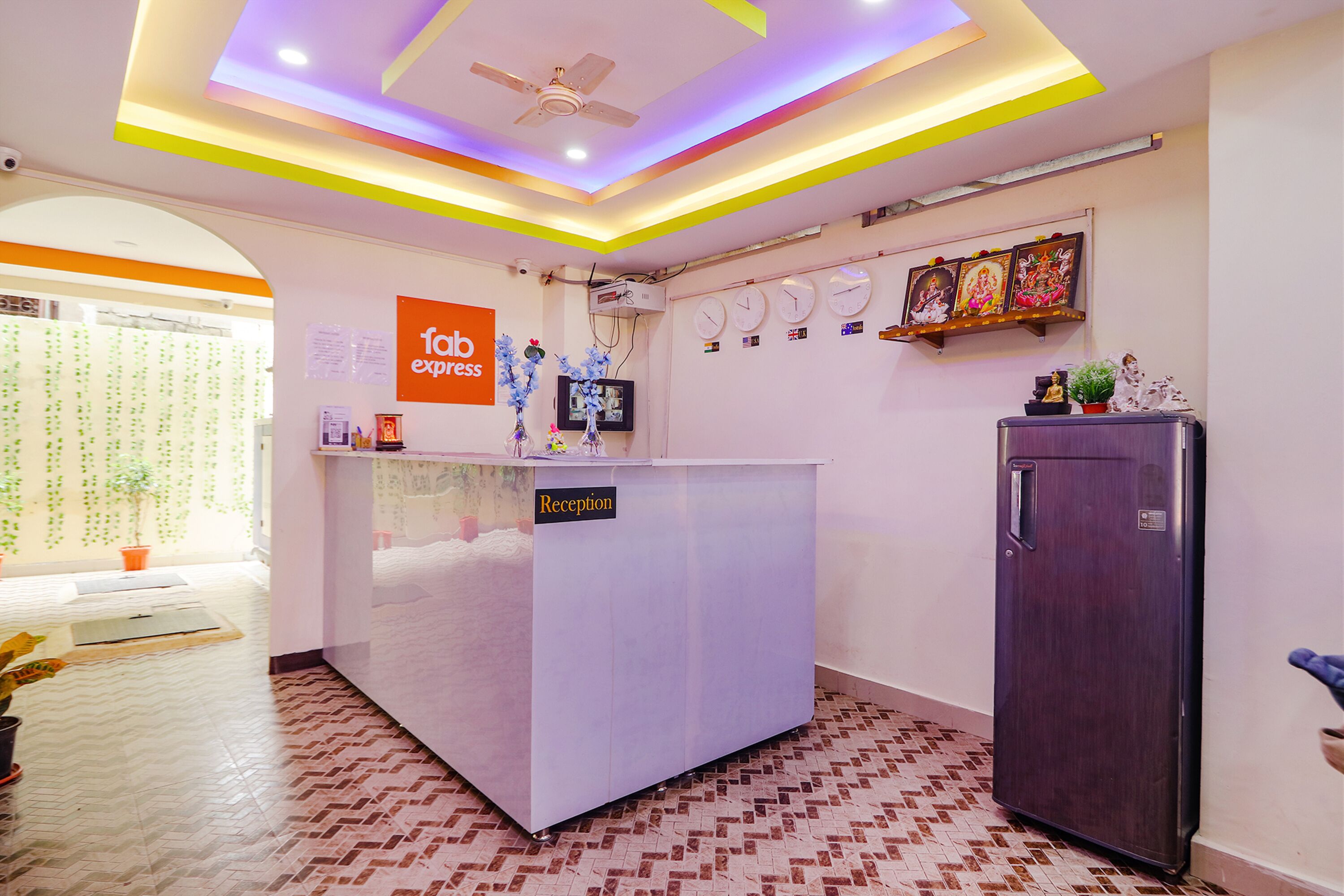 A reception area with a reception desk, a ceiling fan, and a wall-mounted clock.