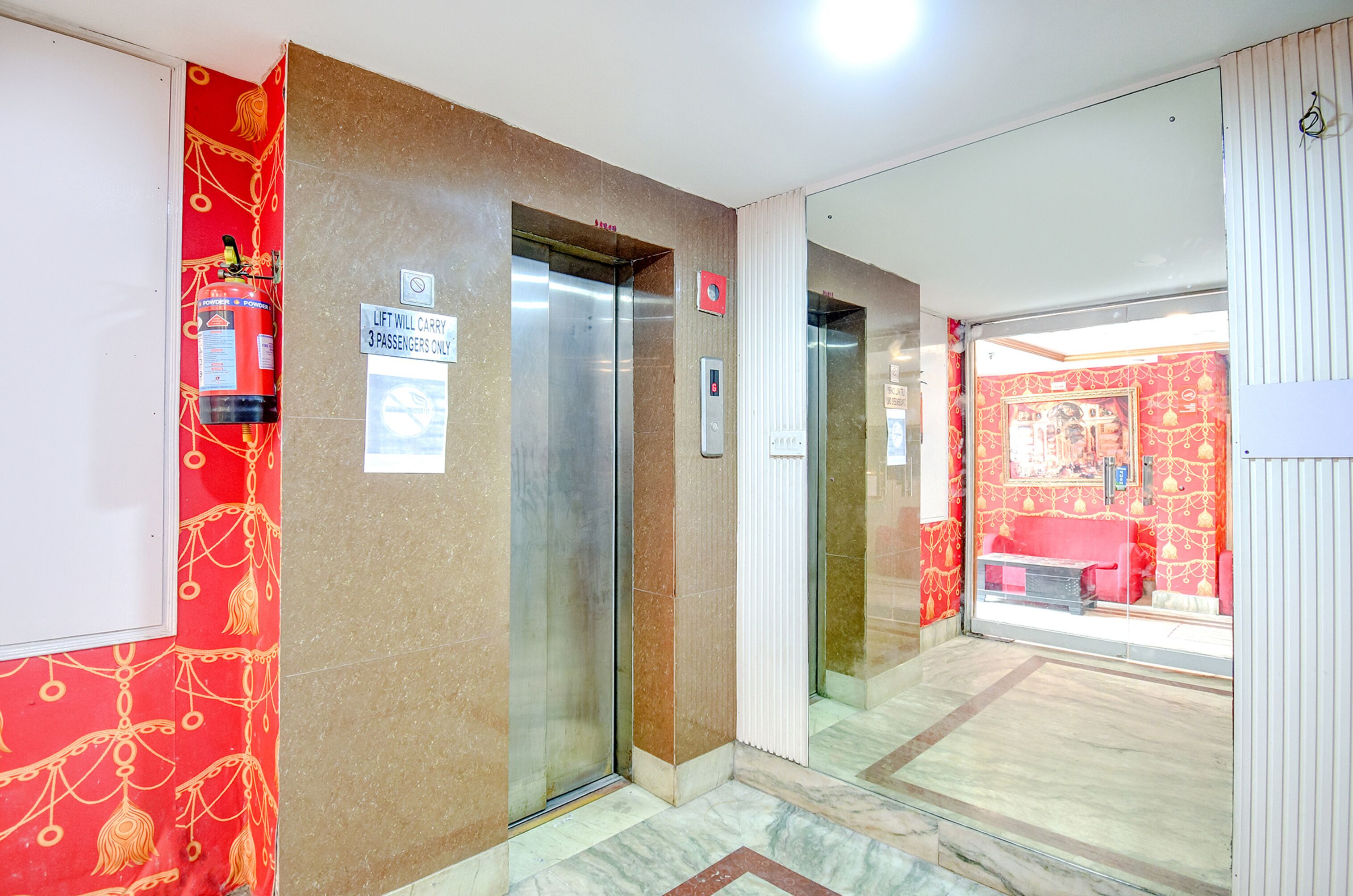 An elevator with a sign indicating it carries 3 passengers only.
