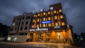 A hotel with a sign for 'Royal Furnitures' and 'FabHotels' on the facade.