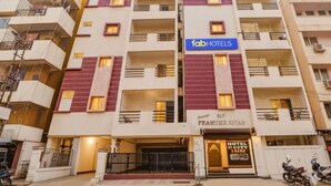 A multi-story building with a sign for 'fabHOTELS' and 'Hotel Ecity Inn'. - Fabhotel E City Inn (Bengaluru)