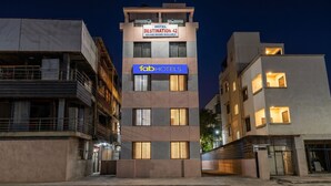 A multi-story hotel with a sign for 'Hotel Destination 42 Deluxe Rooms Available' and 'fabHOTELS' branding. - FabHotel Destination 42 (Pune)