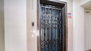 A metal gate with a 'No Outside Food Allowed' sign. - FabHotel Destination 42 (Pune)