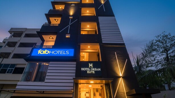 A modern hotel building with a sign for 'fabHOTELS' and 'HOTEL DREAM ELITE'. - FabExpress The Dream Elite (Hyderabad)