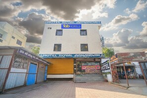 A building with signs for 'Hotel Royal Ganandam' and 'Fab Hotels'.