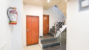 A staircase with metal railings and a wooden door at the top.