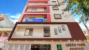 A multi-story building with a 'fabHOTELS' sign, balconies, and a 'GREEN PARK RESIDENCE' sign. - Fabhotel Green Park Residency (Bengaluru)