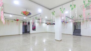 A spacious, well-lit interior with high ceilings and hanging decorations. - FabHotel The Gahmar Inn (Lucknow)