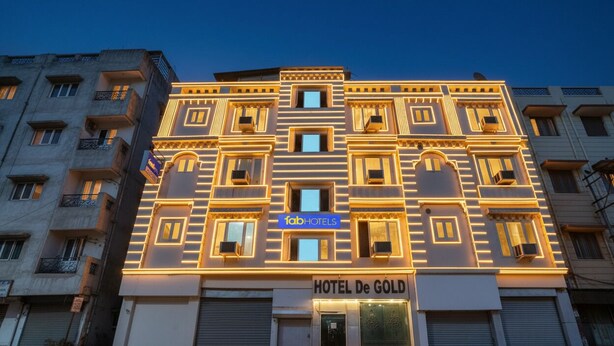 A multi-story hotel with a modern facade, featuring a prominent sign for 'fabHOTELS' and 'HOTEL De GOLD'. - Via De Gold I (New Delhi)