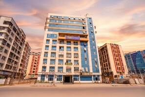 A multi-story hotel with a modern facade, including a prominent 'fabHOTELS' sign. - FabExpress Diamond (Mumbai)