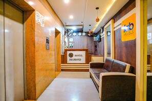 A hotel lobby with a reception desk labeled "Hotel Diamond," a seating area, and a sign for "Fab Hotels." - FabExpress Diamond (Mumbai)